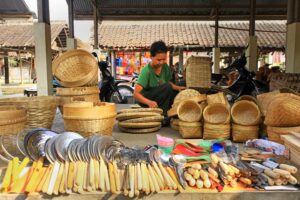 A vibrant market scene showcasing a stall of wicker baskets and utensils.